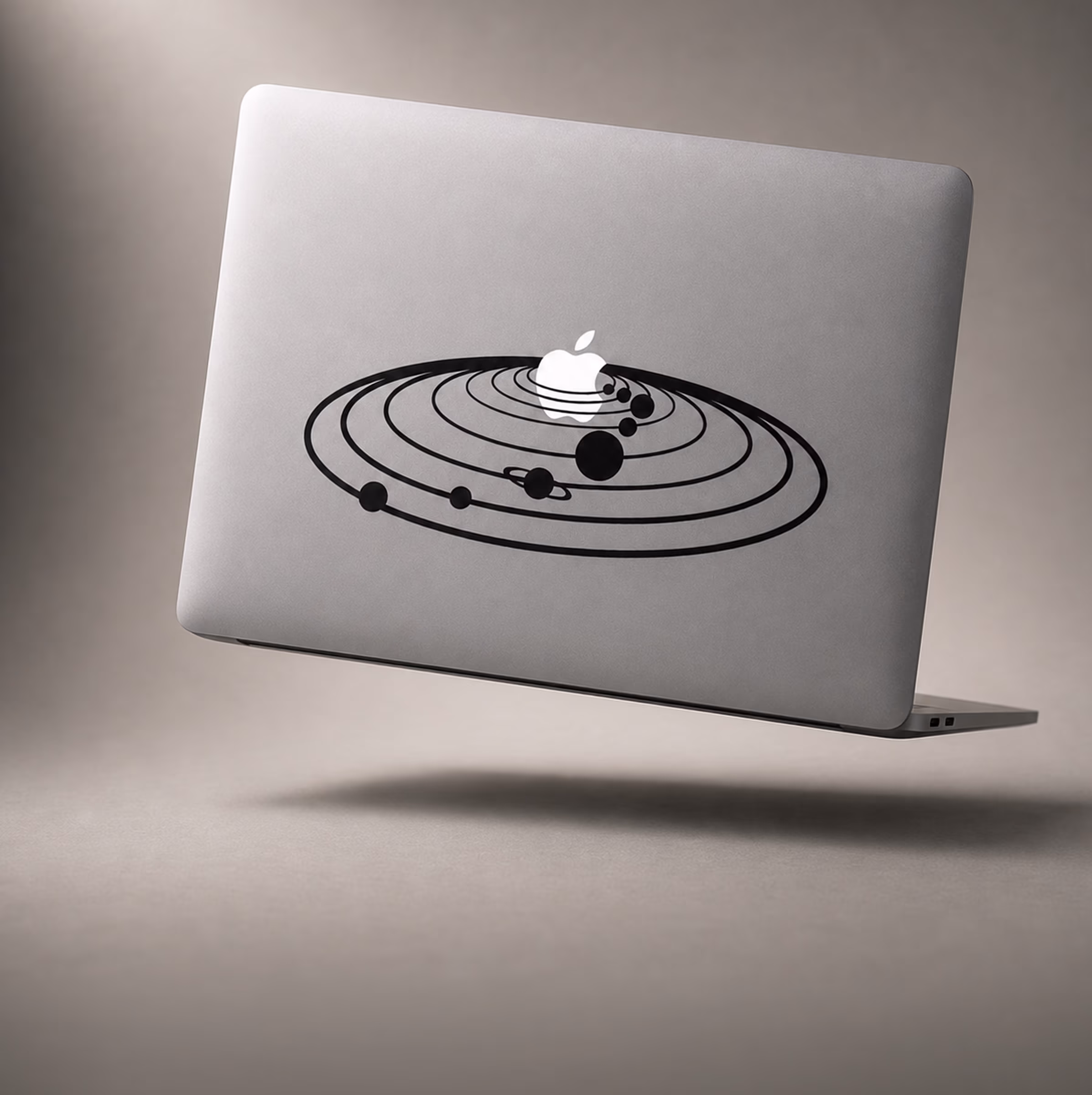 MacBook decal of a solar system with the Apple logo as the sun